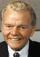 Paul Harvey smiling in a suit, embodying his iconic radio broadcasting persona and storytelling legacy.