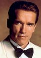 Arnold Schwarzenegger in a tuxedo, showcasing his iconic look from "True Lies," embodying action and charisma.