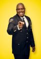 Captain Holt smiling and pointing confidently, wearing an NYPD uniform against a bright yellow backdrop.