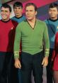 Kirk and crew in colorful uniforms from Star Trek TOS, showcasing iconic characters in a classic sci-fi setting.