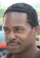 Close-up portrait of a man with short, natural hair and a serious expression, emphasizing themes of urban life and character.