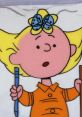 Sally Brown, animated character from 1965-67, holds a pencil and is surprised in a colorful scene.