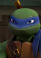 Turtle character Leonardo from TMNT 2012 with a blue bandana and a serious expression, showcasing his iconic look.