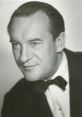 George Sanders, iconic voice of Shere Khan in Disney's The Jungle Book (1967), exuding charm in a classic tuxedo portrait.