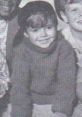 Young Scotty Beckett smiling in a cozy sweater, capturing the charm of childhood in 1934. Classic nostalgia.