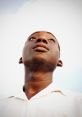 Young man looking up thoughtfully against a clear sky, embodying curiosity and aspiration. Ideal for Buddy DML and Cayla themes.