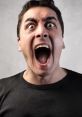 Man screaming with wide-open mouth and intense expression, conveying strong emotions in a neutral background.