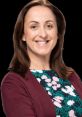 Sonia Fowler smiling, wearing a floral dress with a maroon cardigan, showcasing professional confidence and approachability.