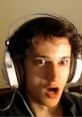 Surprised expression of a gamer wearing headphones, showcasing intense emotions during a livestream or gaming session.