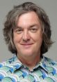 James May from The Grand Tour, smiling with a distinctive patterned shirt, showcasing his unique style and personality.