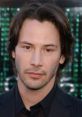 Keanu Reeves posing thoughtfully at a red carpet event, showcasing his signature style and charismatic presence.