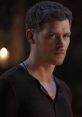 Klaus in a dark setting, showcasing his intense expression, embodying the captivating character from "The Originals.