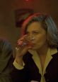 Woman sipping a drink in a dimly lit bar, capturing the atmospheric essence of the film "Barfly.