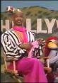 Man in colorful outfit, modeled after a flamboyant sportscaster, on set of "Men On Football - In Living Color.