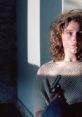 Woman in a sweater holding a gun, capturing the tense atmosphere in "Blood Simple" (1984), a neo-noir film.