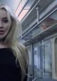 Sabrina Carpenter in a subway setting, embodying the vibe of her song "Thumbs" from the official video.