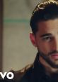 Maluma in "Felices los 4" music video, showcasing his charismatic presence and stylish look in a captivating scene.