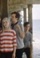 Alvvays band members performing under a pier, capturing the playful vibe of "Archie, Marry Me" official video.