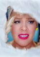 P!nk showcases raw emotion in "Beautiful Trauma" with vibrant makeup and expressive eyes through a torn backdrop.