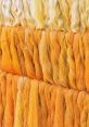 Vibrant strands of silk in shades of yellow and orange, showcasing the natural beauty and texture of silk fibers.