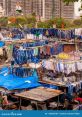 Vibrant colors of clothes drying at Dhobi Ghat, Mumbai, with urban buildings in the background showcasing daily life.