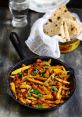 Delicious Arbi stir-fry with spices and herbs, served with fresh roti, perfect for a comforting meal.