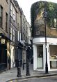 Charming alleyway with traditional brick buildings, shop signs, and a lamppost, creating a quaint urban atmosphere.