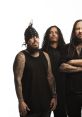 Korn band members pose in a studio, featuring distinctive tattoos and unique styles, capturing their iconic look.