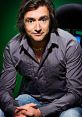 Richard Hammond poses confidently in a stylish grey shirt, showcasing his charismatic personality against a vibrant background.