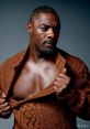 Idris Elba showcases a confident pose in a stylish brown knitted sweater, embodying the essence of "Boasty" charm.