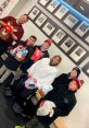 Group of youth hockey players and coach smiling, holding gifts and bags at a community event, showcasing teamwork and joy.