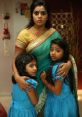 Mother and two daughters in traditional attire, expressing worry, evoking themes of protection and family bonds in "Rakshasi.