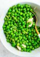 Fresh green peas mixed with garlic and spices in a bowl, showcasing vibrant color and healthy ingredients. Perfect for salads.