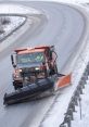 Snowplow clearing a snowy road, ensuring safe winter travel with effective snow removal techniques.