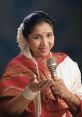 Asha Bhonsle smiling and holding a microphone, dressed in a traditional saree, showcasing her singing talent and charisma.