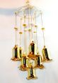 Elegant golden bell chime hanging decor with shimmering bells and decorative beads, perfect for enhancing ambiance.