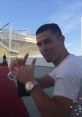 Cristiano Ronaldo gives a thumbs-up gesture, showcasing his signature style and charisma in a casual setting.