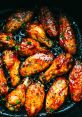 Deliciously glazed chicken wings, perfectly cooked with a glossy finish, garnished with fresh herbs for added flavor.