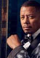 Lucious Lyon exudes confidence in a stylish tuxedo, showcasing charisma against a modern urban backdrop.