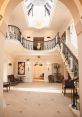 Elegant foyer of Old Down, featuring a grand staircase and decorative chandelier, perfect for events and gatherings.