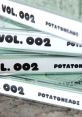 Stack of "Potatoheadz Vol. 002" featuring bold black text on white spines, showcasing unique design and creativity.