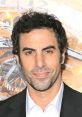 Sacha Baron Cohen at a premiere, showcasing his iconic character Borat from Da Ali G Show in a sophisticated look.