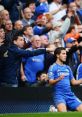 Chelsea fans passionately cheer and celebrate as a player scores, embodying the spirit of football club songs.