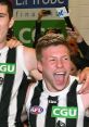 Collingwood players celebrating a victory, showcasing team spirit and joy after singing club songs.