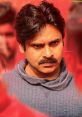 Pawan Kalyan in a dramatic scene, showcasing intense expression against a vibrant red backdrop.