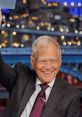 David Letterman smiling and waving during a late-night show, showcasing his iconic style and engaging personality.