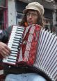 Acordion The of a solo accordion fills the air with a melancholy yet spirited melody. The rich and resonant tones of the