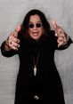 Ozzy Osbourne strikes a dramatic pose with outstretched hands, showcasing his iconic rock star style and captivating presence.