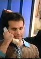 Man on a phone call, smiling, with a retro aesthetic, capturing a moment from a Discovery Channel advert.