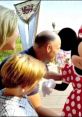 Family enjoying a magical moment with Minnie Mouse at Disney World, capturing joyful memories in a vibrant park setting.